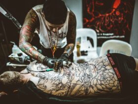 Artist tattooing back