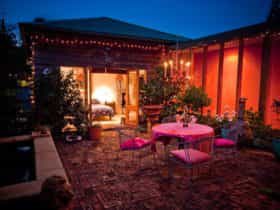 Private courtyard with warm glow of the chandelier and tinkling sounds of the fountain