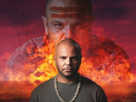 Performer Luke Carroll against fire background
