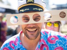 Man looks through beer paddle