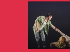 Two people dancing. They are holding hands. One is on the ground. One is standing up.