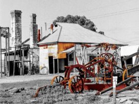 Black and white image of abandoned house with digitally altered accents.