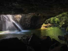 Natural Bridge (rock arch) with waterfall.
