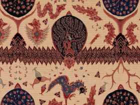 A batik cloth in beige featuring patterns in red across