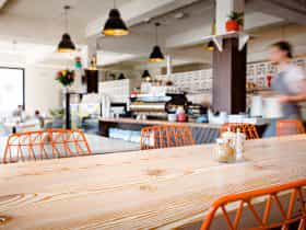 View of the interior of the cafe from our high bench. Pictured is our espresso machine and staff