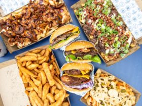 Burgers, fries and drink on a table