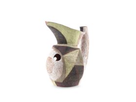 A ceramic jug with green, grey and white hues
