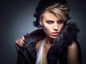 woman in black vest and hat