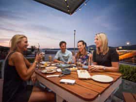 People eating outdoors with views of the lake