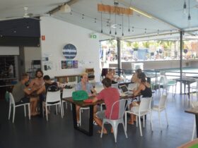 Guests sitting in the dining room at Youth Shack Backpackers.